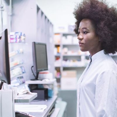 Photo of a lady working looking at a computer screen